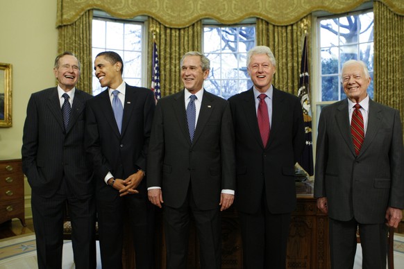 FILE - In this Wednesday, Jan. 7, 2009 file photo, President-elect Barack Obama is welcomed by President George W. Bush for a meeting at the White House in Washington, with former presidents, from lef ...
