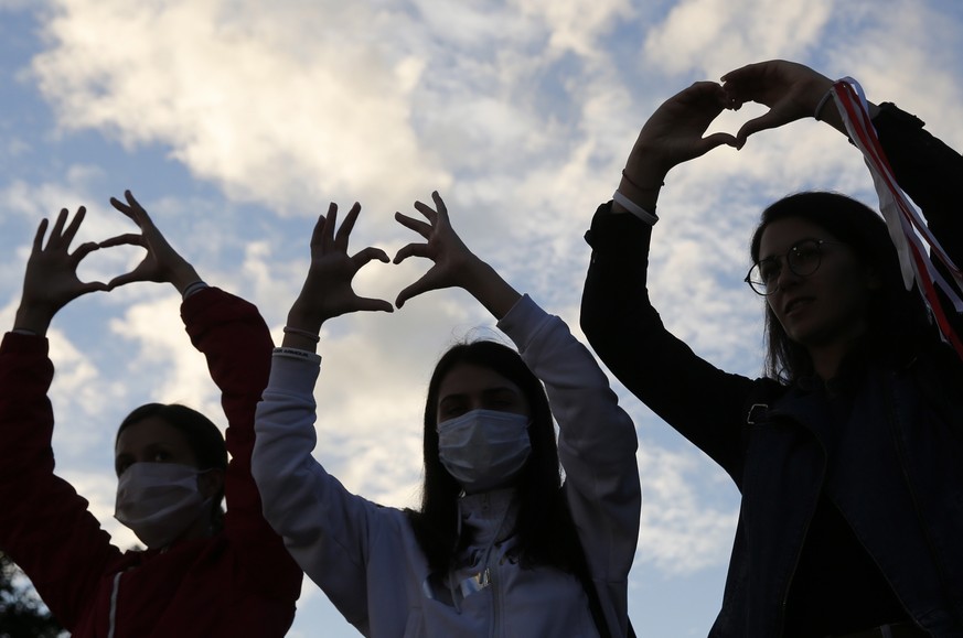 epa08632529 Belarus women show heart signs during a peaceful protest rally against the results of the presidential elections, in Minsk, Belarus 28 August 2020. Opposition protests in Belarus continue  ...