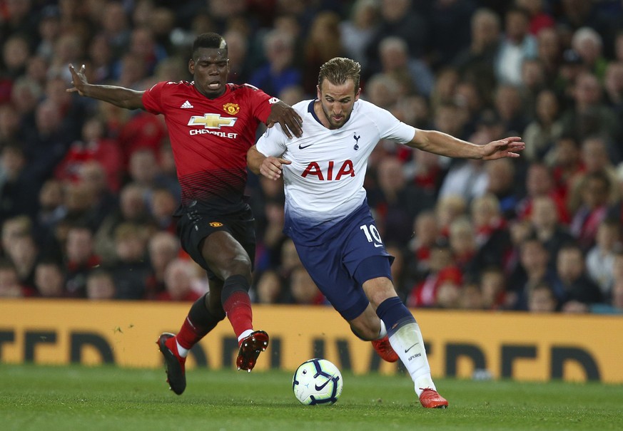 Tottenham Hotspur&#039;s Harry Kane, right, is challenged by Manchester United&#039;s Paul Pogba during the English Premier League soccer match between Manchester United and Tottenham Hotspur at Old T ...
