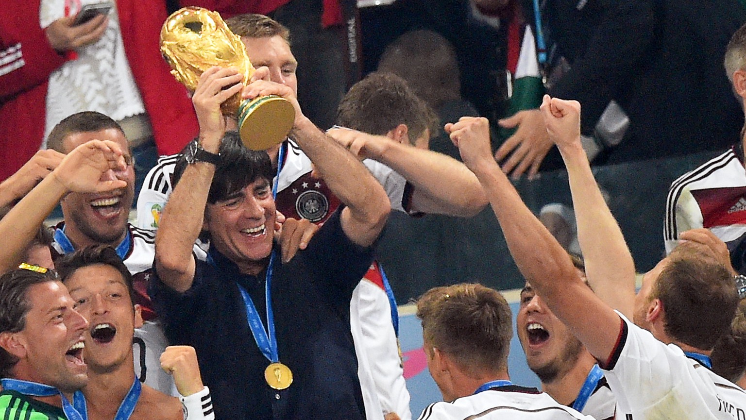 epa09063325 (FILE) - Germany&#039;s head coach Joachim Loew (C) lifts the World Cup trophy as his teammates celebrate after winning the FIFA World Cup 2014 final between Germany and Argentina at the E ...