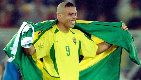 Brazil forward Ronaldo celebrates with the Brazilian flag after they defeated Germany 2-0 in the 2002 World Cup final Sunday, June 30, 2002 in Yokohama, Japan. (AP Photo/Amy Sancetta)