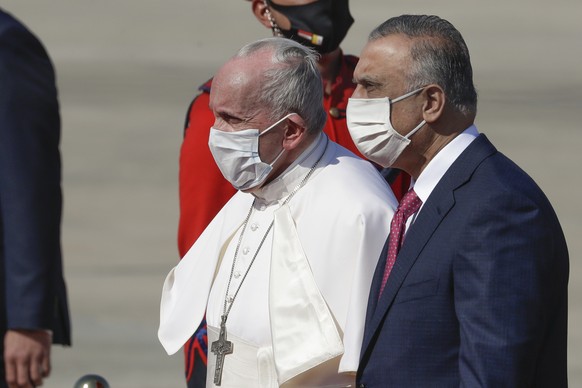 Pope Francis is flanked by Iraqi Prime Minister Mustafa al-Kadhimi upon hi arrival at Baghdad&#039;s international airport, Iraq, Friday, March 5, 2021. Pope Francis heads to Iraq on Friday to urge th ...