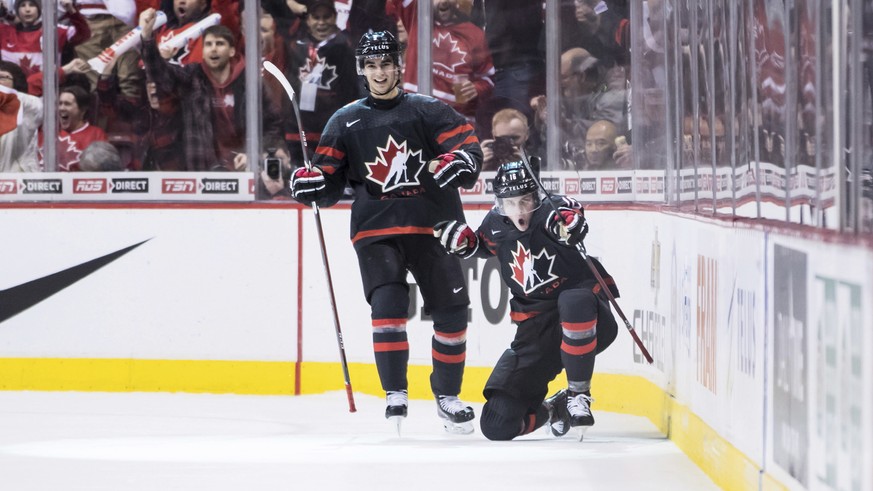 Canada&#039;s MacKenzie Entwistle, front right, and Joe Veleno celebrate Entwistle&#039;s goal against the Czech Republic during second-period IIHF world junior hockey championship game action in Vanc ...