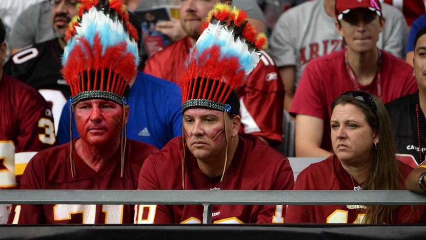 Three Washington Redskins fans don t look happy during the first half of the Redskins-Arizona Cardinals game at the University of Phoenix Stadium in Glendale, Arizona on October 12, 2014. PUBLICATIONx ...