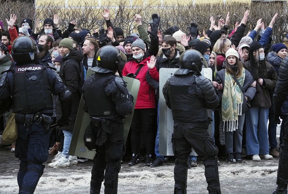 Protesters stand surrounded by police during a protest against the jailing of opposition leader Alexei Navalny in St. Petersburg, Russia, Sunday, Jan. 31, 2021. Thousands of people took to the streets ...