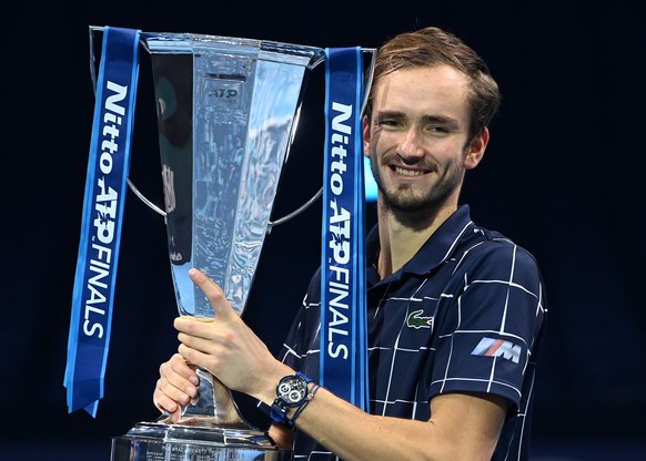 epa08836665 Daniil Medvedev of Russia celebrates with his trophy after winning against Dominic Thiem of Austria their final match at the ATP World Tour Finals tennis tournament in London, Britain, 22  ...