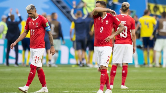 Switzerland&#039;s soccer players Valon Behrami, Haris Seferovic, and Josip Drmic, from left to right, react during the FIFA World Cup 2018 round of 16 soccer match between Sweden and Switzerland at t ...