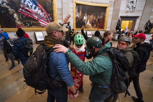 epaselect epa08923416 Supporters of US President Donald J. Trump in the Capitol Rotunda after breaching Capitol security in Washington, DC, USA, 06 January 2021. Protesters entered the US Capitol wher ...
