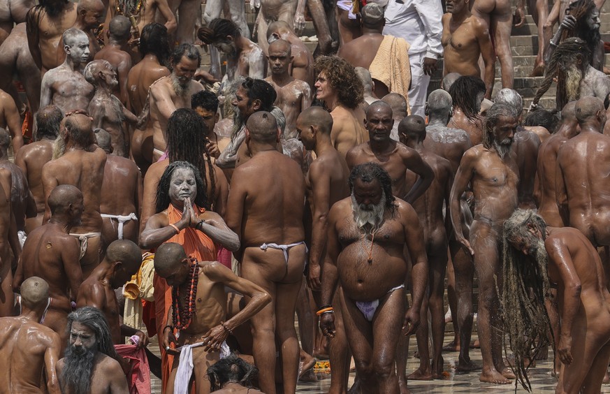 Naked Hindu holy men gather to take holy dips in the Ganges River during Kumbh Mela, or pitcher festival, one of the most sacred pilgrimages in Hinduism, in Haridwar, northern state of Uttarakhand, In ...