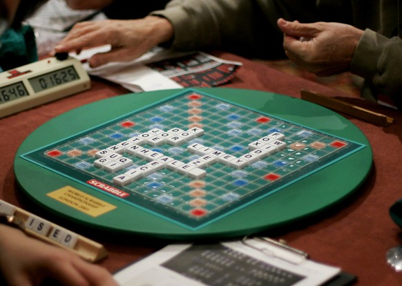 FILE - In this Thursday, Nov. 17, 2005 file photo, competitors take part in the World Scrabble Championships at an hotel in north west London. The Association of British Scrabble players has banned on ...