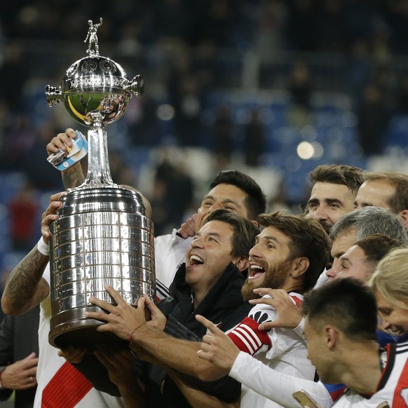 FILE - In this Dec. 9, 2018 file photo, Marcelo Gallardo, coach of Argentina&#039;s River Plate, celebrates with the championship trophy after defeating Argentina&#039;s Boca Juniors at the Copa Liber ...