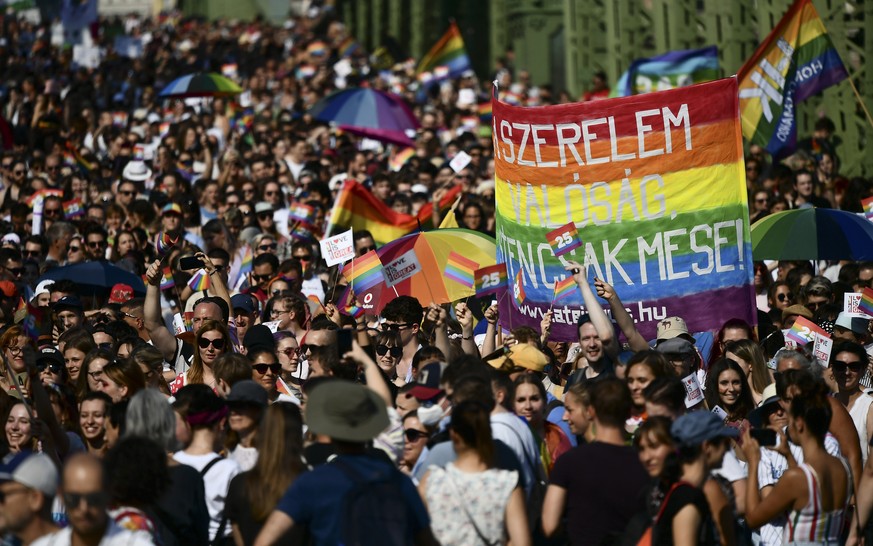 People march across the Szabadsag, or Freedom Bridge over the River Danube in downtown Budapest during a gay pride parade in Budapest, Hungary, Saturday, July 24, 2021. Rising anger over policies of H ...