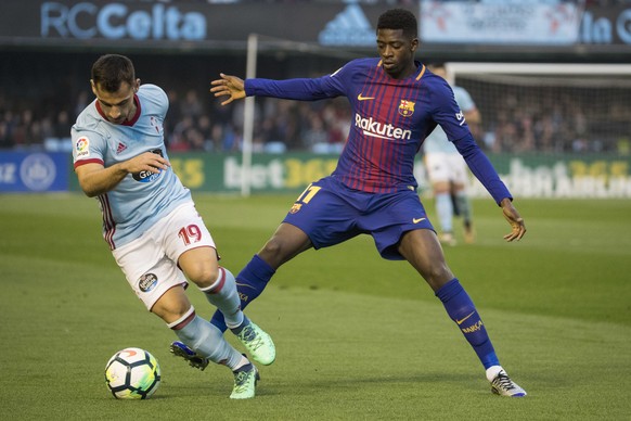 RC Celta&#039;s Jonny Otto, left, challenges for the ball with Barcelona&#039;s Ousmane Dembele during a Spanish La Liga soccer match between RC Celta and Barcelona at the Balaidos stadium in Vigo, Sp ...