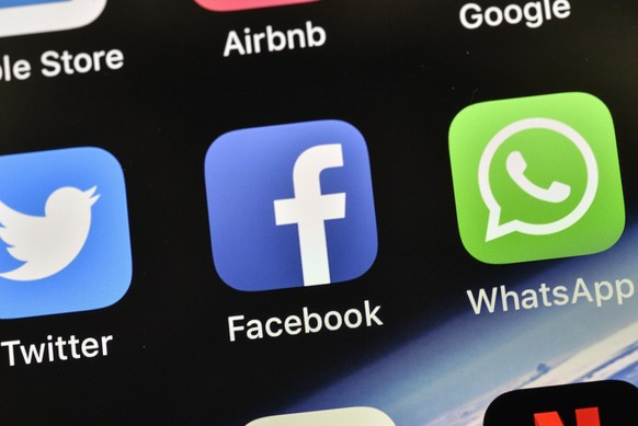FILE - In this Thursday, Nov. 15, 2018 file photo, the icons of Facebook and WhatsApp are pictured on an iPhone, in Gelsenkirchen, Germany. Facebook&#039;s WhatsApp faces a complaint from European Uni ...