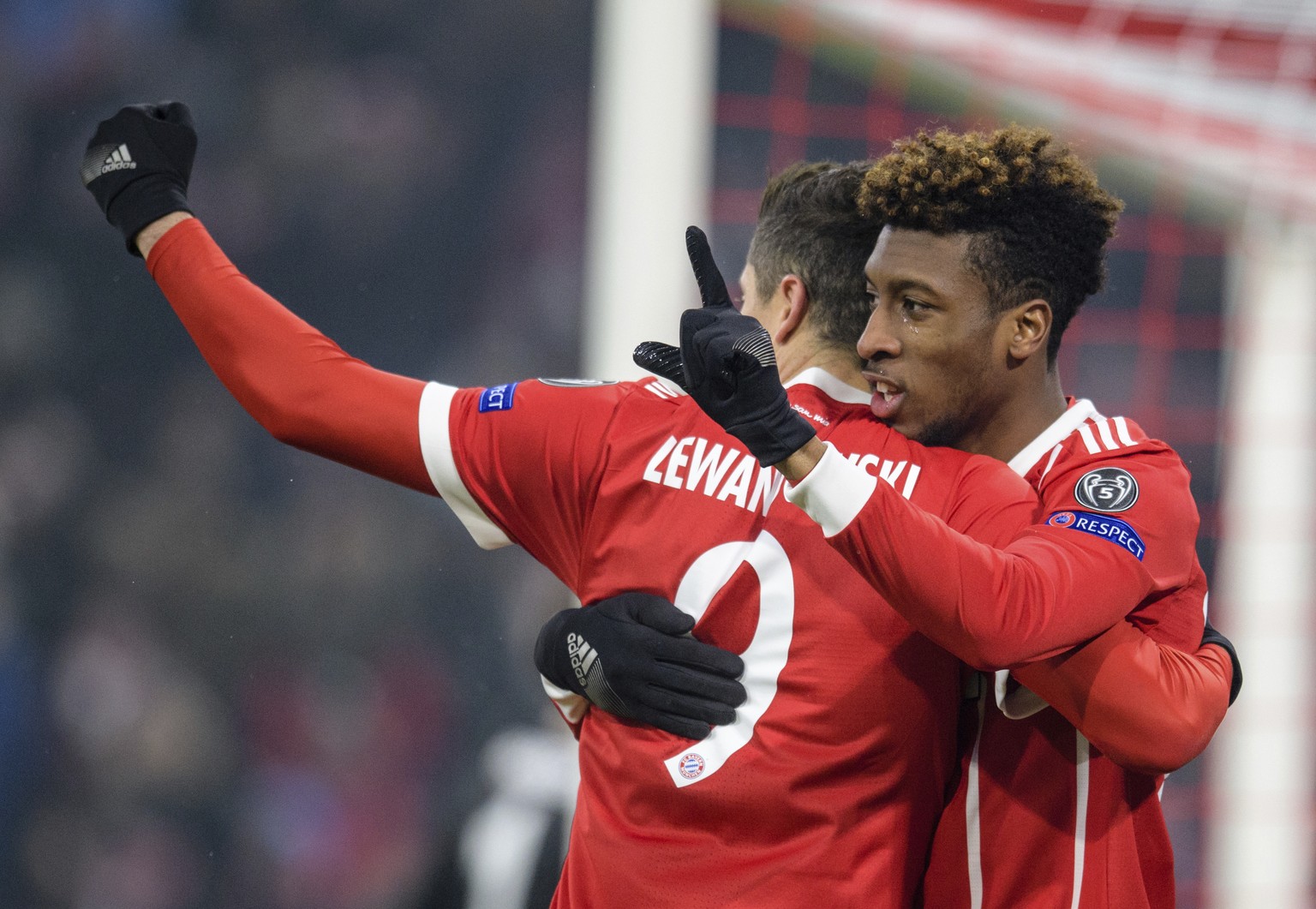 Bayern&#039;s Robert Lewandowski, left, congratulates Kingsley Coman who scored their second goal during the Champions League round of 16 first leg soccer match between Bayern Munich and Besiktas Ista ...