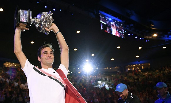 Switzerland&#039;s Roger Federer holds his trophy aloft after defeating Croatia&#039;s Marin Cilic during the men&#039;s singles final at the Australian Open tennis championships in Melbourne, Austral ...