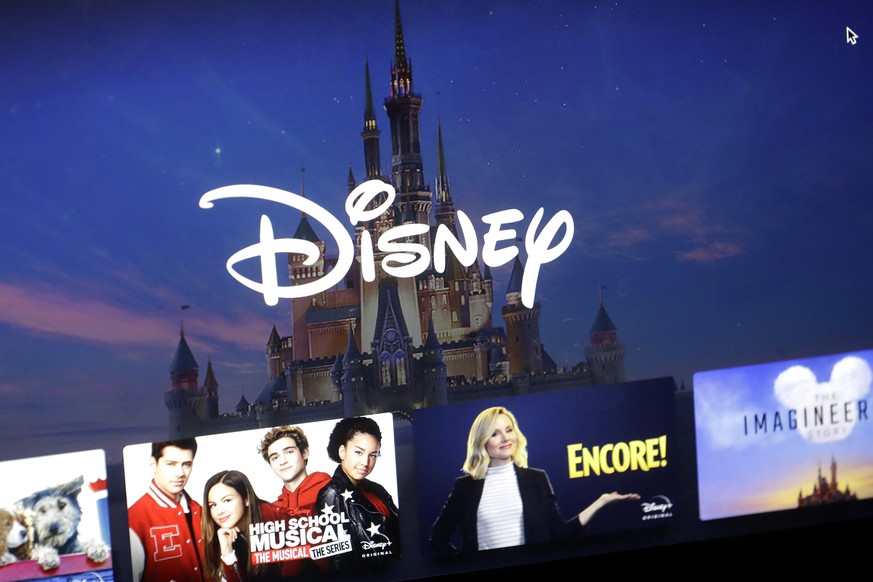 FILE - In this Wednesday, Nov. 13, 2019 file photo, a Disney logo forms part of a menu for the Disney Plus movie and entertainment streaming service on a computer screen in Walpole, Mass. Analysts pre ...
