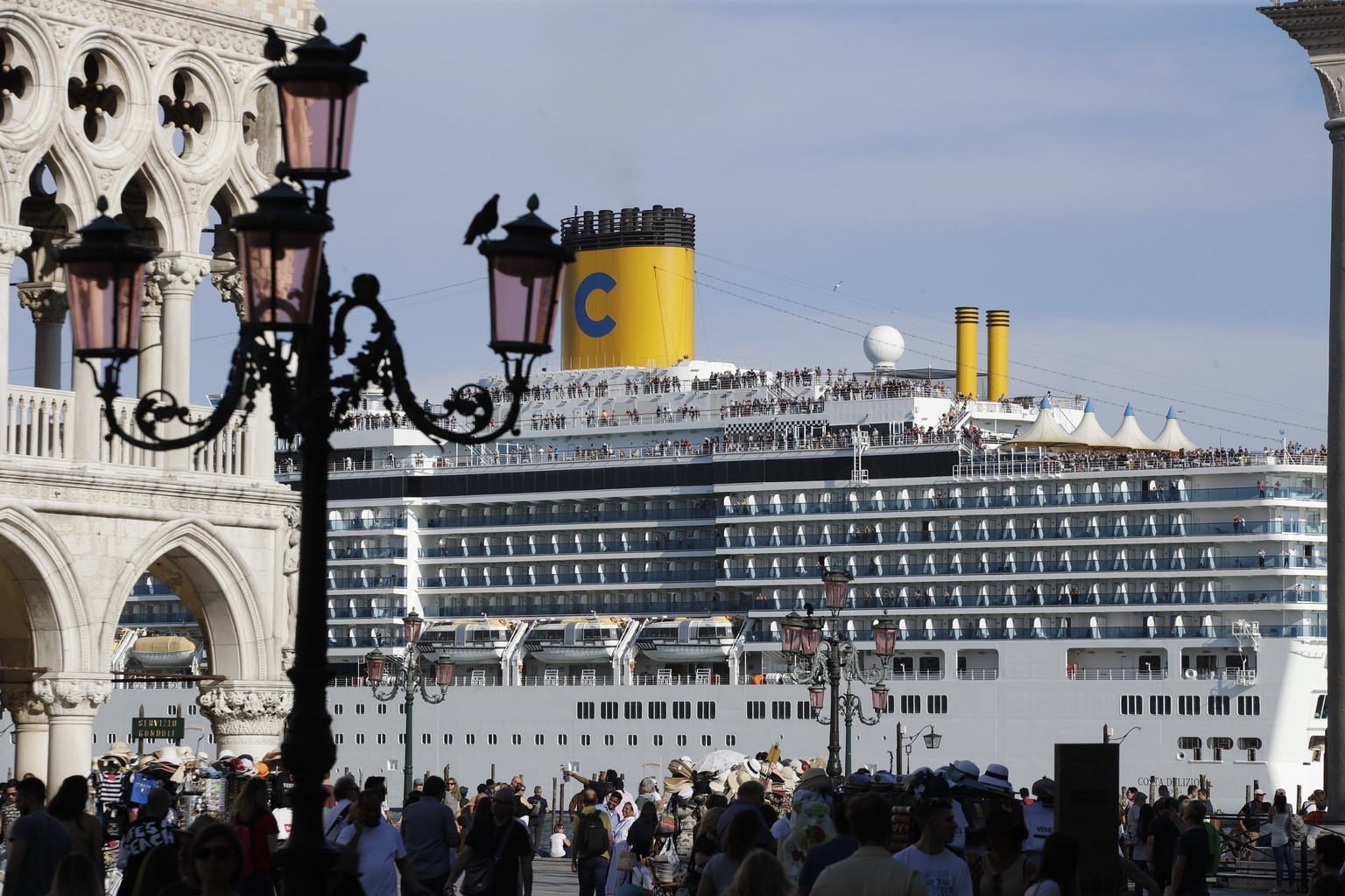 A cruise ship passes by St. Mark&#039;s Square filled with tourists, in Venice, Italy, Sunday, June 2, 2019. Groups that want to ban cruise ships on Venice&#039;s busy canals say a collision that inju ...