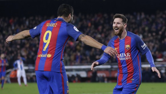 FC Barcelona&#039;s Lionel Messi, right, celebrates after scoring with his teammate Luis Suarez during the Spanish La Liga soccer match between FC Barcelona and Espanyol at the Camp Nou in Barcelona,  ...