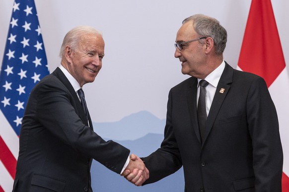 epa09273943 Swiss Federal president Guy Parmelin greets US president Joe Biden, ahead of bilateral talks on the sidelines of the US-Russia summit held a day later, in Geneva, Switzerland, 15 June 2021 ...
