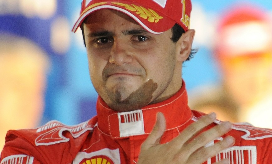 Ferrari&#039;s driver Felipe Massa of Brazil holds back tears on the podium after he won the Brazilian Grand Prix but missed to secure the 2008 Formula One world drivers championship title at Interlag ...
