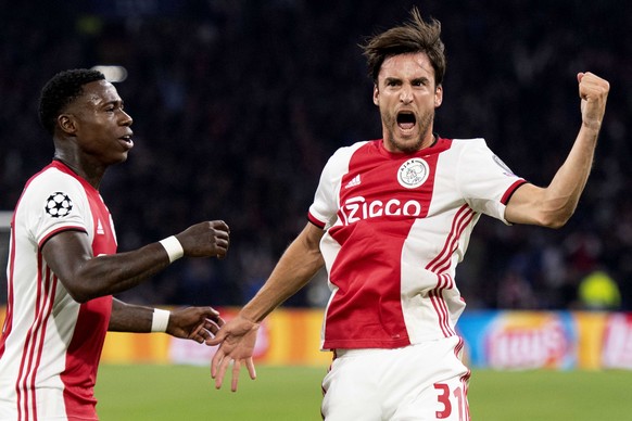 epa07849522 Nico Tagliafico (R) of Ajax celebrates with teammate Quincy Promes his 3-0 goal during the UEFA Champions League match between Ajax Amsterdam and OSC Lille in Amsterdam, Netherlands, 17 Se ...