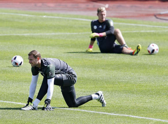 Manuel Neuer, left, and Marc-André ter Stegen attend a training session of the German national soccer team at their base camp of the German national soccer team in Evian-Les-Bains, France, Wednesday,  ...