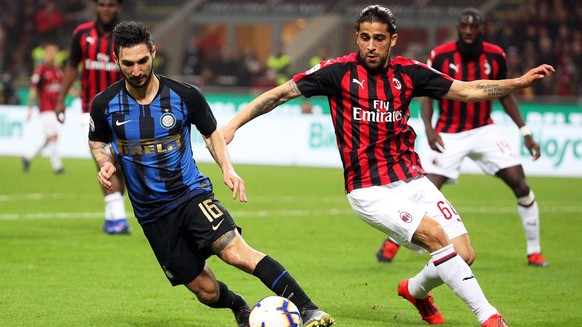 epa07445888 Inter&#039;s Matteo Politano (L) in action against AC Milan&#039;s Ricardo Rodriguez (R) during the Italian Serie A soccer match between AC Milan and Inter Milan at Giuseppe Meazza stadium ...