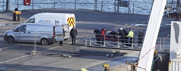A stretcher carrying a body is removed from the Geo Ocean III specialist search vessel docked in Portland, England, Thursday Feb. 7, 2019. A body has been recovered from the wreckage of the plane carr ...