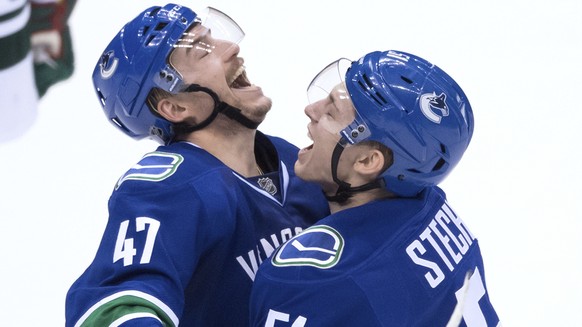 Vancouver Canucks&#039; Sven Baertschi, left, and Troy Stecher celebrate Baertschi&#039;s goal against the Minnesota Wild during the third period of an NHL hockey game Tuesday, Nov. 29, 2016, in Vanco ...
