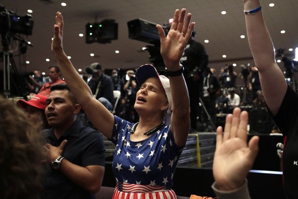 Wanda Albritton, of Miami Springs, Fla., raises her ams in prayer during a rally for evangelical supporters at the King Jesus International Ministry church, Friday, Jan. 3, 2020, in Miami. (AP Photo/L ...