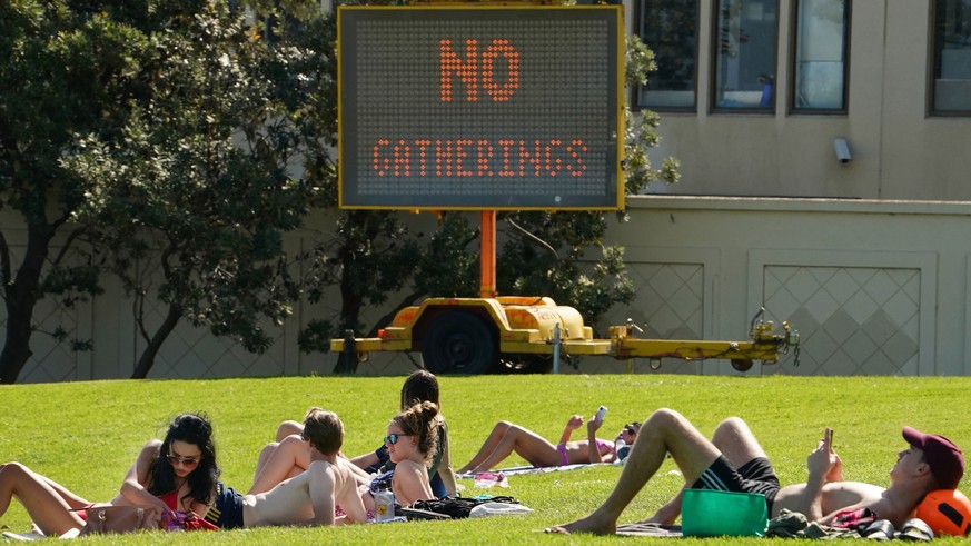 epa08331742 People sunbathe at St Kilda Beach in Melbourne, Australia, 28 March 2020. (issued 30 March 2020) Port Phillip City Council has clamped down on large groups accessing all of its beaches inc ...