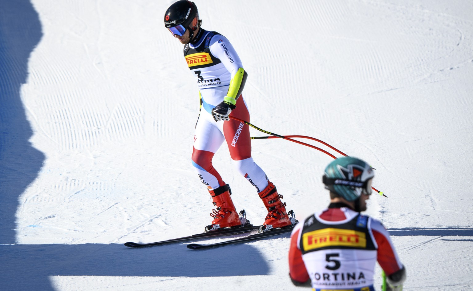 Mauro Caviezel of Switzerland, left, reacts next to Vincent Kriechmayr of Austria, right, in the finish area during the men&#039;s Super-G race at the 2021 FIS Alpine Skiing World Championships in Cor ...