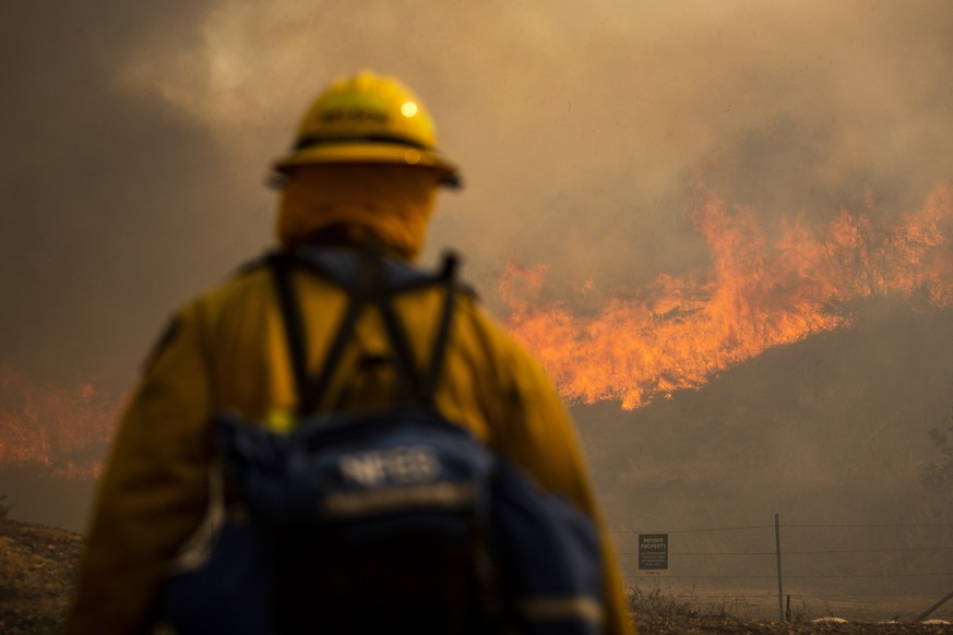 epaselect epa08776268 Firefighters work at controlling the Silverado Fire burning near Irvine in Orange County, South of Los Angeles, California, USA, 26 October 2020. Some 60,000 people were evacuate ...