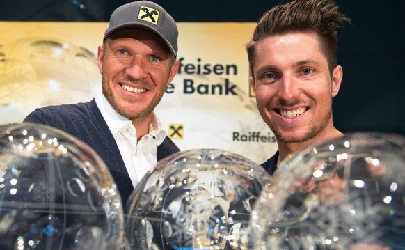 epa05227023 Austrian skier Marcel Hirscher (R) and former Austrian skier Hermann Maier (L) pose next to Hirscher&#039;s five overall FIS Alpine Skiing World Cup trophies during a press conference in V ...