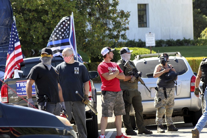 Armed right-wing protesters in support of President Donald Trump stand in front of the Oregon State Capitol in Salem, Ore., Monday, Sept. 7, 2020. Hundreds of people gathered on Labor Day in a small t ...