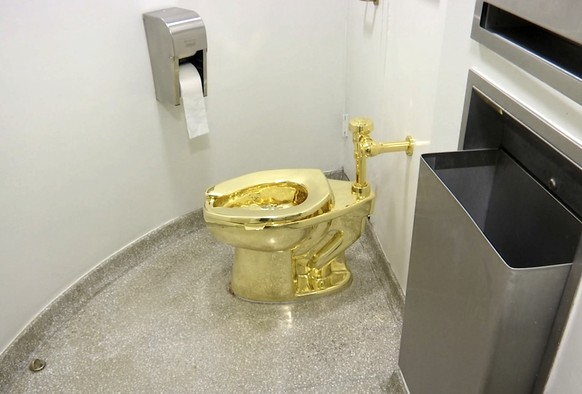 FILE - This Sept. 16, 2016 file image made from a video shows the 18-karat toilet, titled &quot;America,&quot; by Maurizio Cattelan in the restroom of the Solomon R. Guggenheim Museum in New York. Thi ...