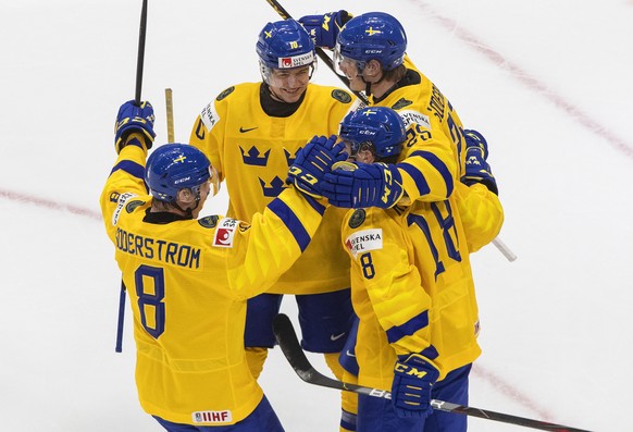 Sweden&#039;s Victor Soderstrom (8), Lucas Raymond (18), Alexander Holtz (10), and Elmer Soderblom (25) celebrate a goal against Finland during the first period of an IIHF World Junior Hockey Champion ...