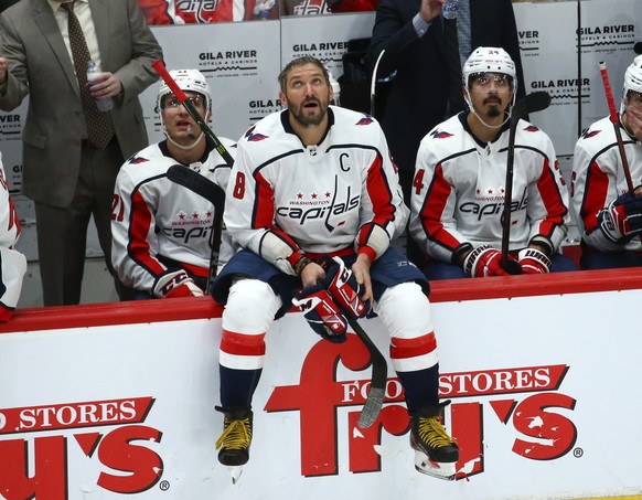 Washington Capitals right wing Garnet Hathaway (21), Capitals left wing Alex Ovechkin (8) and Capitals defenseman Jonas Siegenthaler, right, look at the scoreboard in the closing minutes of their loss ...