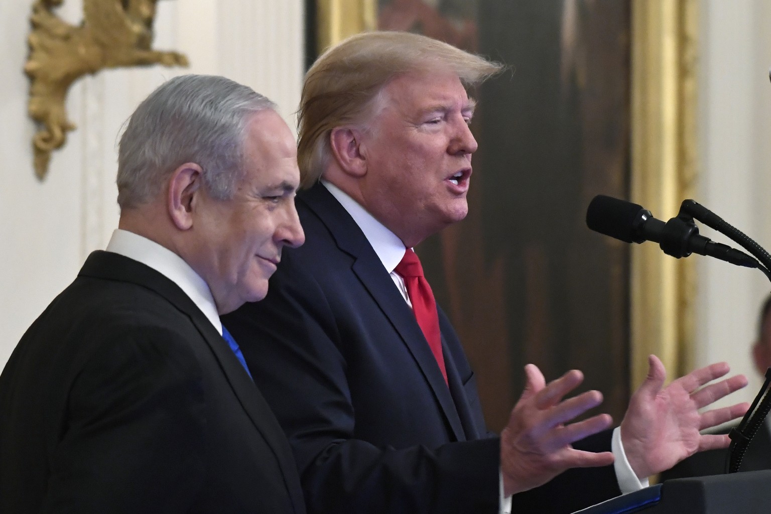 President Donald Trump, right, speaks during an event with Israeli Prime Minister Benjamin Netanyahu, left, in the East Room of the White House in Washington, Tuesday, Jan. 28, 2020, to announce the T ...