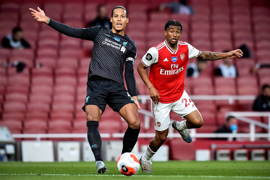 epa08548422 Liverpool&#039;s Virgil van Dijk (L) in action against Arsenal&#039;s Reiss Nelson (R) during the English Premier League soccer match between Arsenal London and Liverpool FC in London, Bri ...