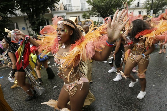 FILE - In this Monday, Aug. 31, 2015 file photo, a costumed reveller performs in the Notting Hill Carnival in London. London&#039;s Notting Hill Carnival traces its roots to the emancipation of Black  ...