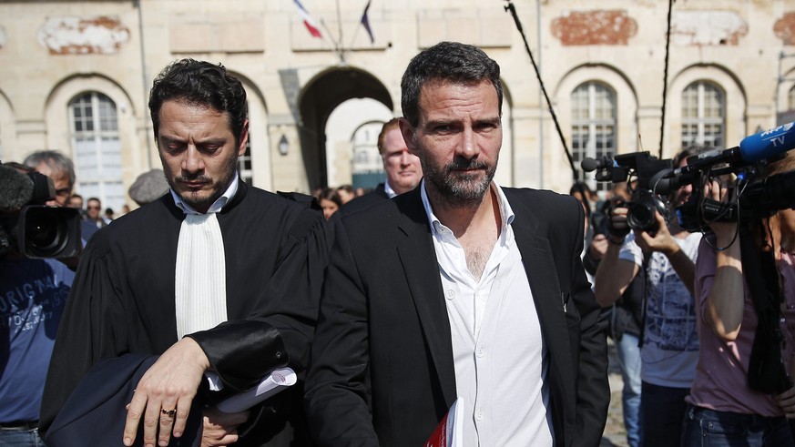 epa05553143 French former Societe Generale rogue trader Jerome Kerviel (C) leaves the Versailles appeal court after fighting a civil damages case with his lawyer David Koubbi (L), in Versailles, Franc ...