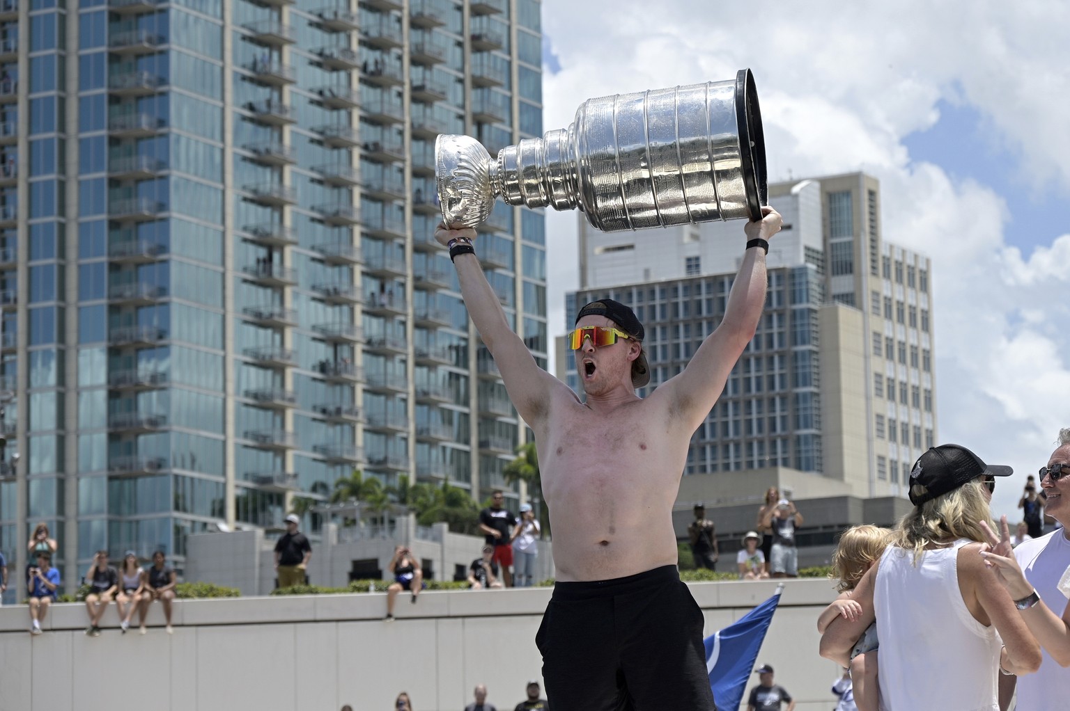 Tampa Bay Lightning center Blake Coleman hoists the Stanley Cup during the NHL hockey Stanley Cup champions&#039; Boat Parade, Monday, July 12, 2021, in Tampa, Fla. (AP Photo/Phelan M. Ebenhack)