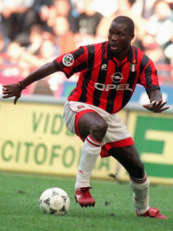 Milan&#039;s forward George Weah, left, dribbles past Napoli defender Mirko Taccola during their Italian major league match in Milan Sunday, October 20, 1996. Weah scored first two goals in Milan&#039 ...