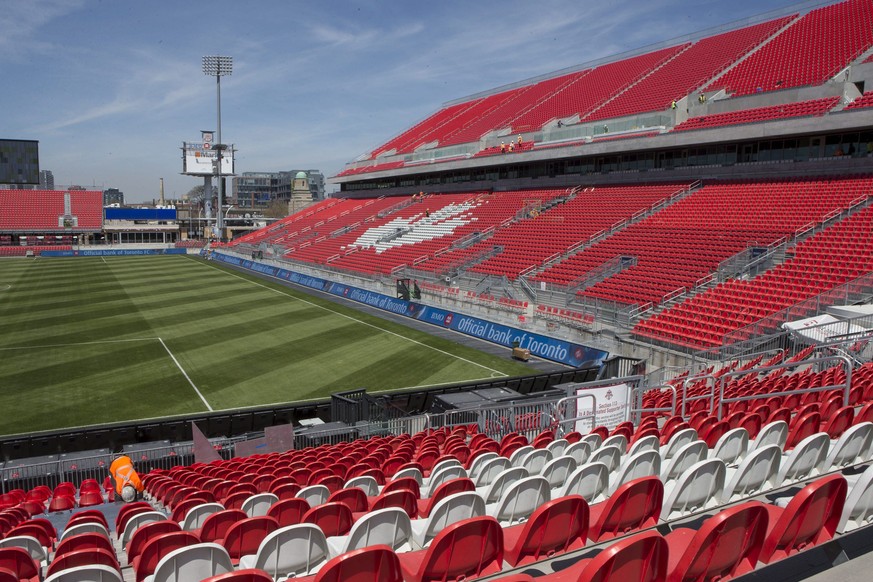 A worker fixes a seat at Toronto FC&#039;s BMO Field on Thursday, May 7, 2015, as work continues to ready the newly revamped stadium ahead of the Sunday home opener. (Chris Young/The Canadian Press vi ...
