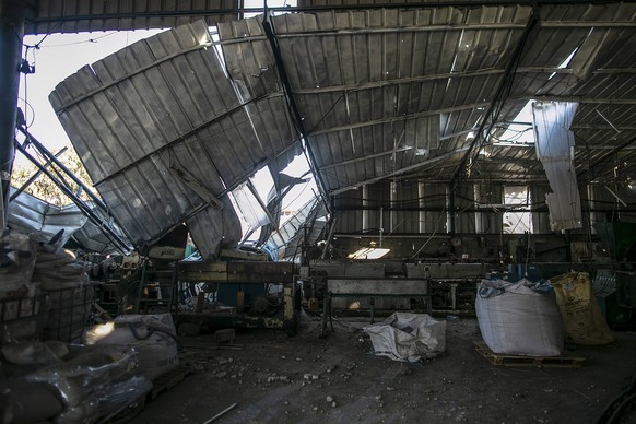 epa08904684 A damaged factory near a street that Israel reportedly attacked after Palestinian militants fired rockets at Israel, in Gaza City, 26 December 2020. The Israeli army said that three allege ...