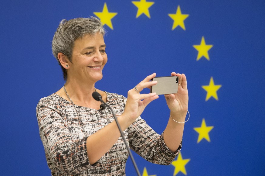 epa08547013 (FILE) - EU Commissioner for Competition Margrethe Vestager uses an Apple iPhone to take a picture of the room from the podium as her news conference begins at the Delegation of the Europe ...