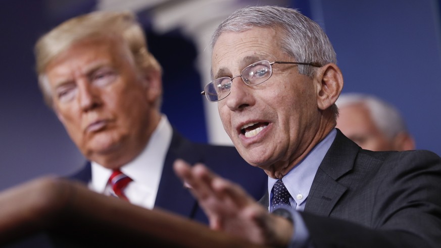 epa08310093 Director of the National Institute of Allergy and Infectious Diseases Anthony Fauci (R) speaks as US President Donald Trump (L) listens during a Coronavirus Task Force news conference in t ...
