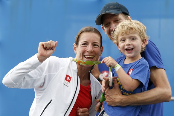 Silver medal winner Nicola Spirig of Switzerland celebrates with her family after the women’s Triathlon in Fort Copacabana at the Rio 2016 Olympic Summer Games in Rio de Janeiro, Brazil, pictured on S ...